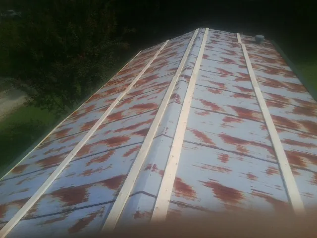 Rusted metal roof panels with new wood purlins before replacement — Storm Damage Roof Repair in Dalmatia by Roofing Brothers